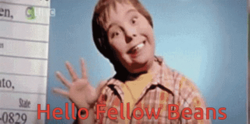 A Young Boy Says Hello Fellow Beans In Front Of A Whiteboard GIF