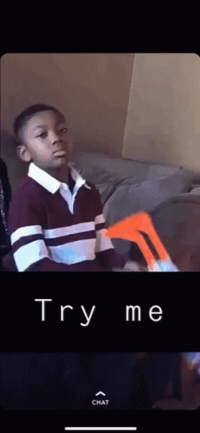 A Young Boy Sitting On A Couch With The Words Try Me Written On The Bottom Of The Screen GIF