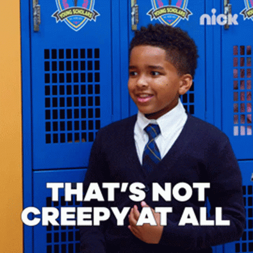 A Young Boy Standing In Front Of Blue Lockers That Say Young Scholars GIF