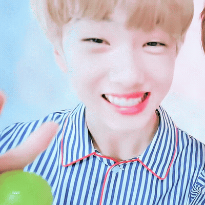 A Young Boy Wearing A Blue And White Striped Shirt Is Smiling GIF