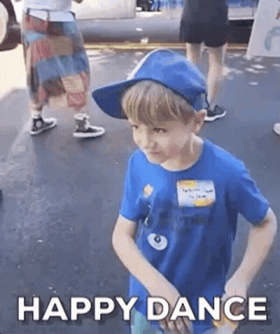 A Young Boy Wearing A Blue Shirt And A Blue Hat Is Dancing . GIF