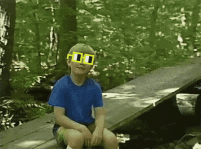 A Young Boy Wearing A Blue Shirt And Yellow Sunglasses GIF