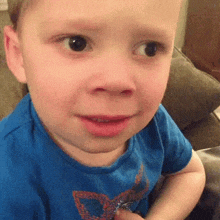 A Young Boy Wearing A Blue Shirt With A Heart On It GIF