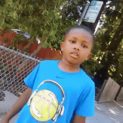 A Young Boy Wearing A Blue T-Shirt With A Basketball And Headphones On It . GIF