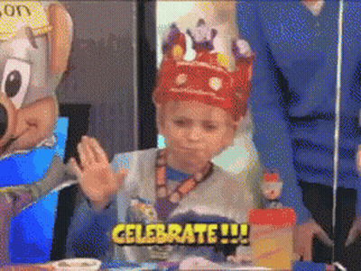 A Young Boy Wearing A Crown Says Celebrate !!! GIF