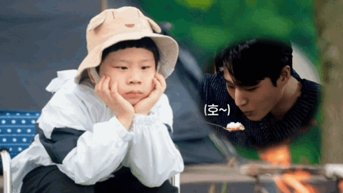 A Young Boy Wearing A Hat Is Sitting Next To A Man Eating Rice GIF