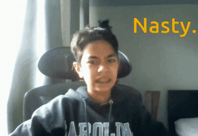 A Young Boy Wearing A Hoodie That Says Arolin Is Sitting In A Chair GIF