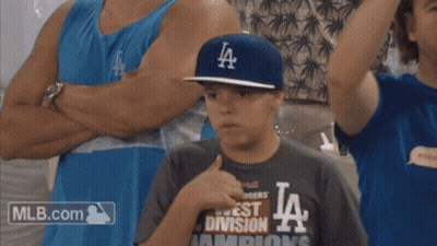 A Young Boy Wearing A La Hat And A Mlb.com Shirt GIF