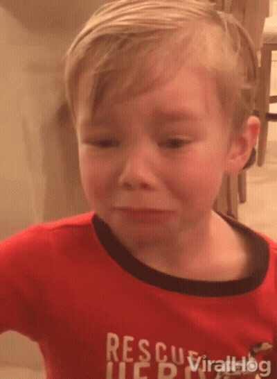 A Young Boy Wearing A Red Rescue Shirt Is Crying GIF