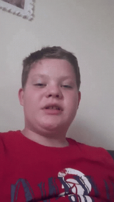 A Young Boy Wearing A Red Shirt That Says ' Abercrombie & Fitch ' On It GIF