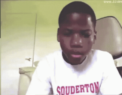 A Young Boy Wearing A Shirt That Says Souderton On It GIF