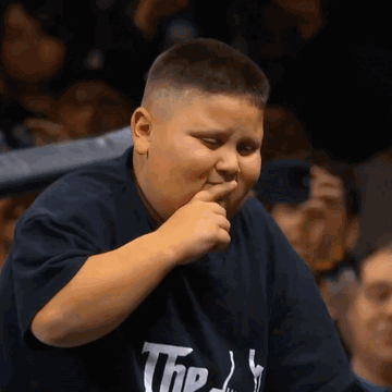 A Young Boy Wearing A Shirt That Says The ' S ' On It GIF