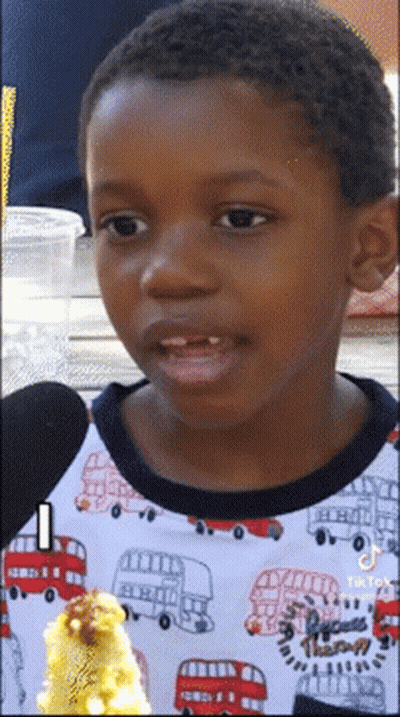 A Young Boy Wearing A Shirt With A Double Decker Bus On It GIF