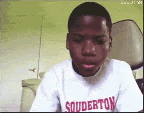 A Young Boy Wearing A Souderton Shirt Is Making A Funny Face GIF