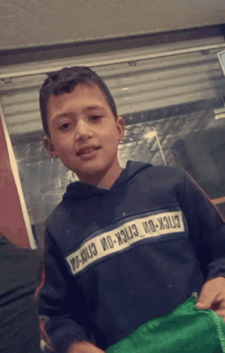 A Young Boy Wearing A Sweatshirt That Says Stick-On-Stick-On-Stick-On GIF