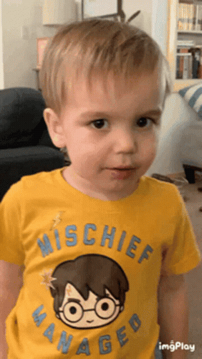 A Young Boy Wearing A Yellow Shirt That Says Mischief Managed On It GIF
