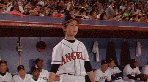A Young Boy Wearing An Angel Jersey Stands In The Dugout GIF