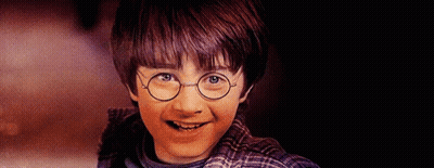 A Young Boy Wearing Glasses And A Plaid Shirt Is Smiling GIF