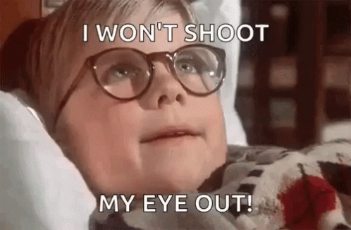 A Young Boy Wearing Glasses Is Laying In Bed With Blood On His Shirt . GIF