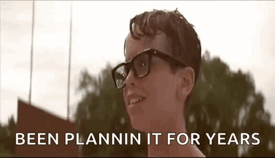 A Young Boy Wearing Glasses Is Smiling With The Words `` Been Plannin It For Years '' Behind Him . GIF