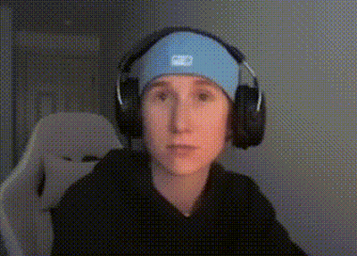 A Young Boy Wearing Headphones And A Headband Is Sitting In A Chair . GIF