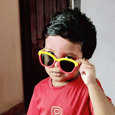 A Young Boy Wearing Sunglasses And A Red Shirt With A Letter P On It GIF