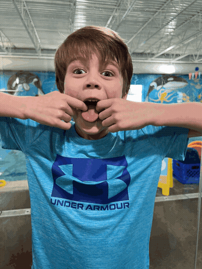 A Young Boy Wears A Blue Under Armour Shirt GIF