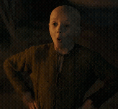 A Young Boy With A Bald Head Is Giving A Thumbs Up . GIF