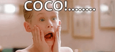 A Young Boy With A Surprised Look On His Face Is Holding His Face With His Hands . GIF
