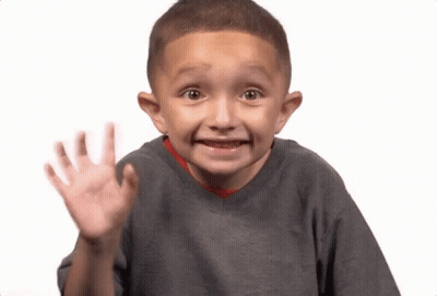 A Young Boy With A Surprised Look On His Face Is Waving GIF
