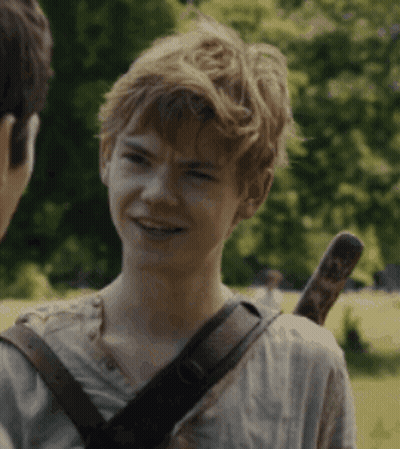 A Young Boy With A Sword On His Back Is Smiling And Talking To Another Person GIF
