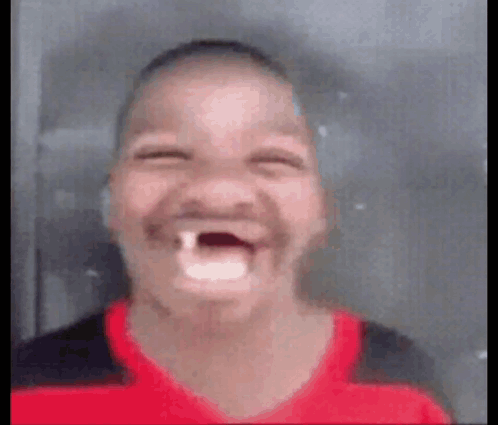 A Young Boy With A Tooth Missing Is Making A Funny Face With His Mouth Open . GIF
