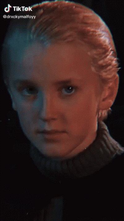 A Young Boy With Blonde Hair And A Nose Ring Is Smiling For The Camera . GIF