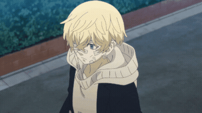 A Young Boy With Blonde Hair And Blue Eyes Is Walking Down A Street GIF