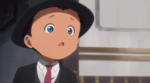 A Young Boy With Blue Eyes Is Wearing A Black Hat And Tie GIF