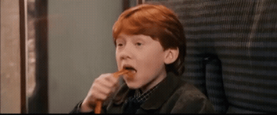A Young Boy With Red Hair Is Eating A Carrot GIF