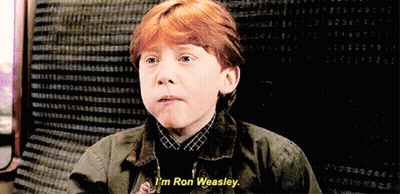 A Young Boy With Red Hair Says " I 'M Ron Weasley " In Front Of A Black Background GIF