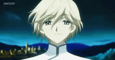 A Young Boy With White Hair And Blue Eyes Is Standing In Front Of A Blue Background . GIF