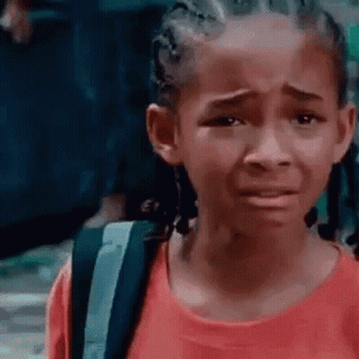 A Young Girl In A Red Shirt Is Crying With A Backpack . GIF