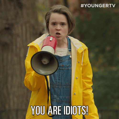 A Young Girl In A Yellow Raincoat Is Holding A Megaphone And Says You Are Idiots GIF