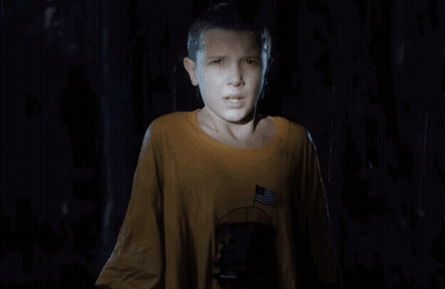 A Young Girl In A Yellow Shirt With An American Flag On The Pocket GIF
