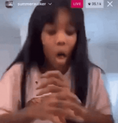 A Young Girl Is Making A Funny Face While Holding A Cell Phone . GIF