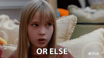 A Young Girl Sitting On A Couch With The Words Or Else Written On Her Face GIF
