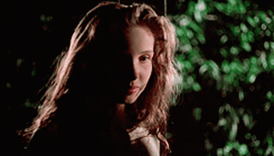 A Young Girl With Long Hair Is Sitting On A Swing In The Dark . GIF