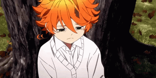 A Young Girl With Orange Hair Is Sitting Under A Tree With Her Eyes Closed . GIF