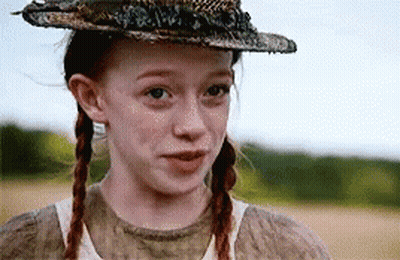 A Young Girl With Pigtails Wearing A Hat And A White Shirt . GIF