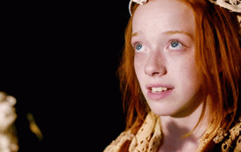 A Young Girl With Red Hair And Blue Eyes GIF