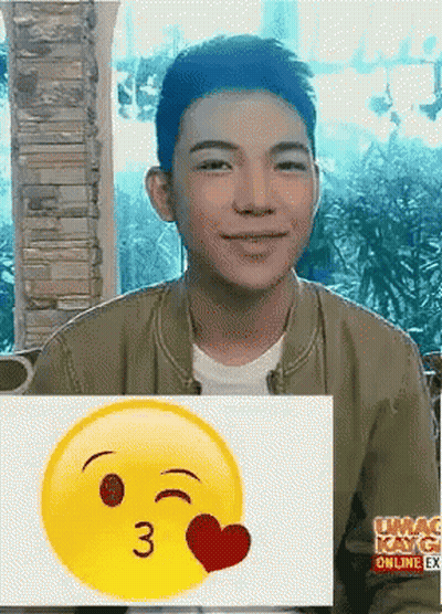 A Young Man Behind A Smiley Face That Says 3 On It GIF
