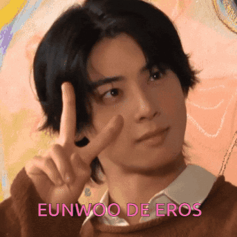 A Young Man Giving A Peace Sign With The Name Eunwoo De Eros Written Below Him GIF