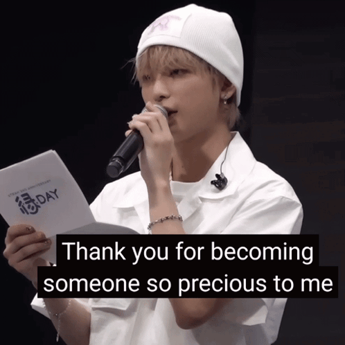 A Young Man Holding A Microphone And A Piece Of Paper That Says " Thank You For Becoming Someone So Precious To Me " GIF